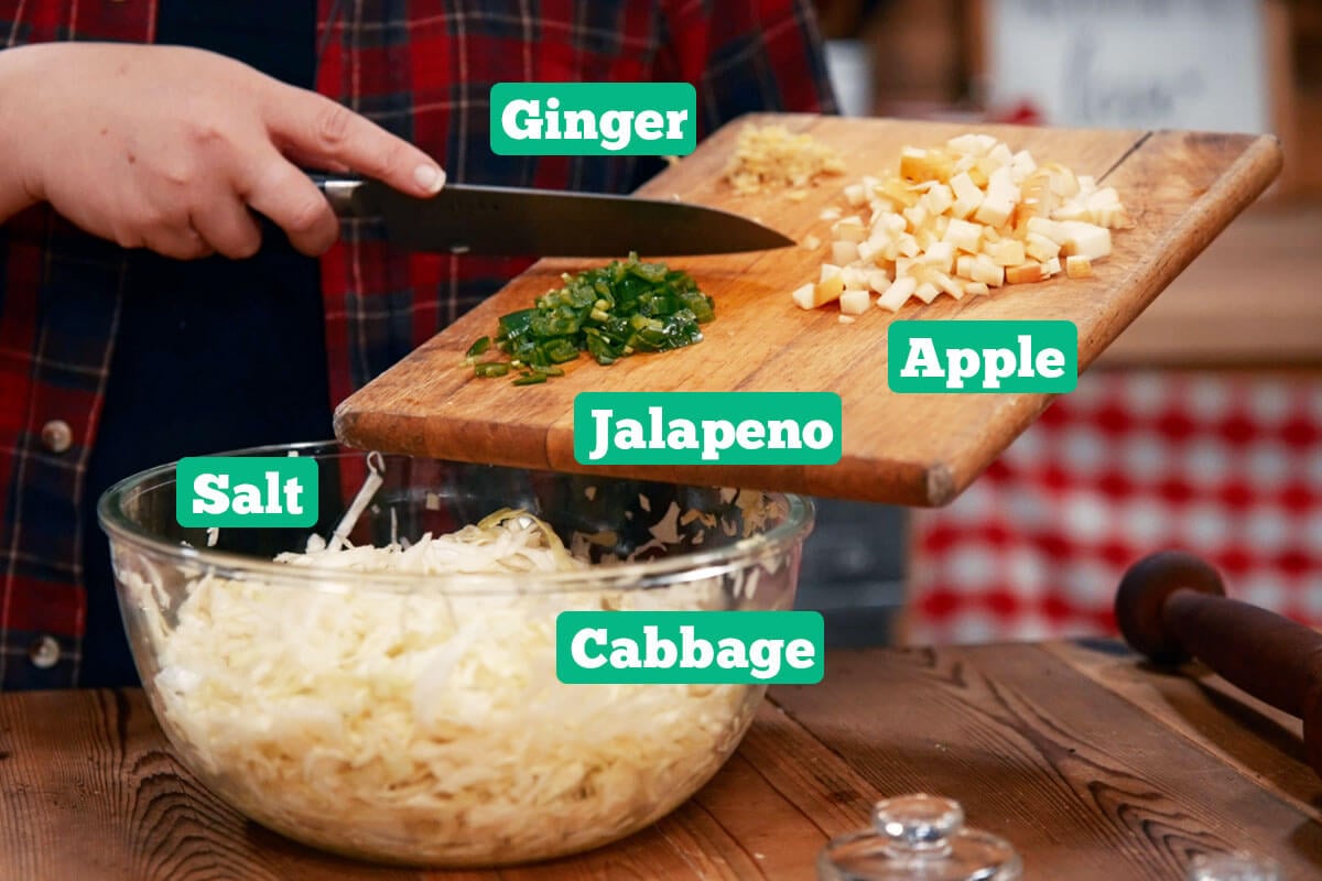 Sweet and spicy apple sauerkraut ingredients: cabbage, jalapenos, apple, and ginger.