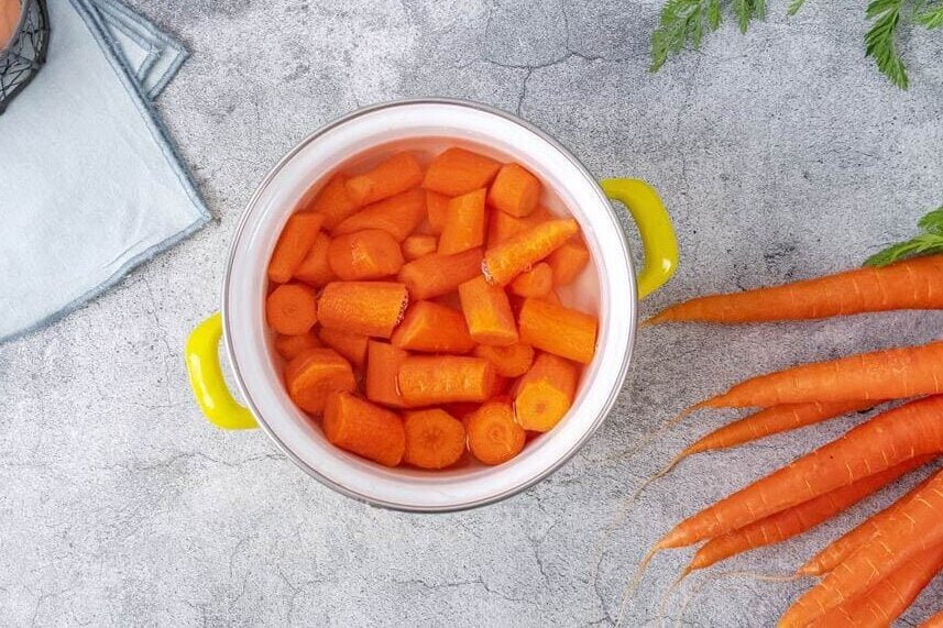 Carrots in a pot covered in water.