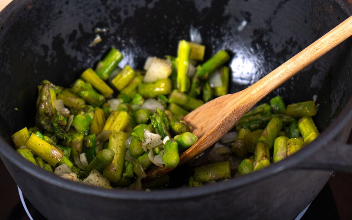 Asparagus cooking in a pan.
