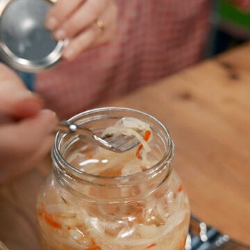 A fork with a bite of homemade Curtido on it.