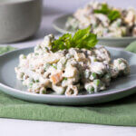 Frozen green pea salad served on a gray plate and garnished with parsley.