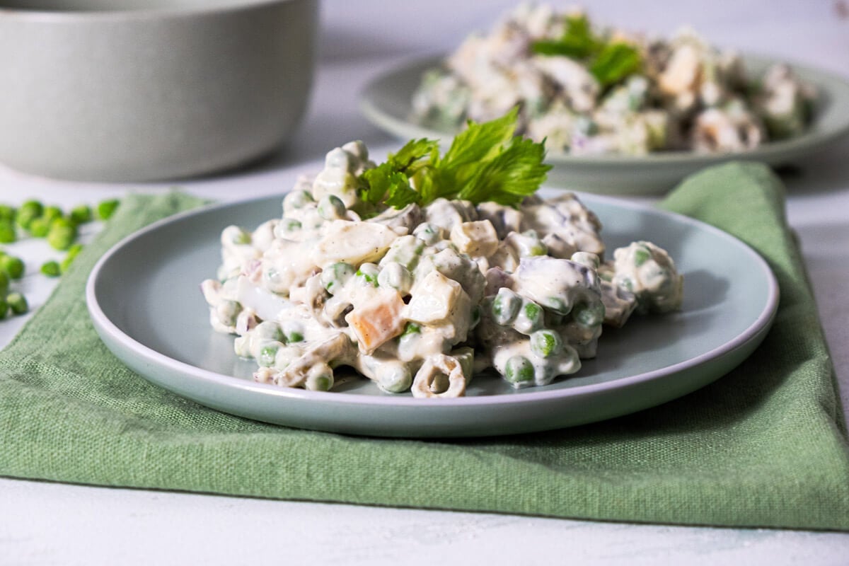 Frozen green pea salad served on a gray plate and garnished with parsley.