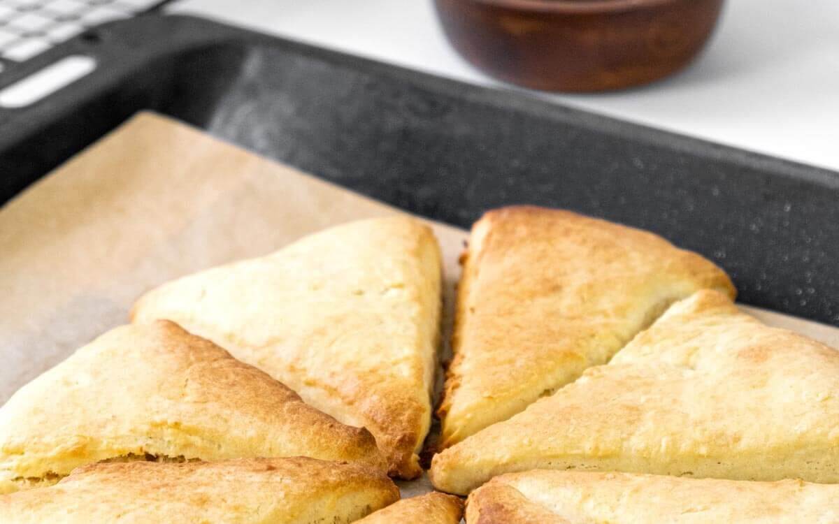 Fresh baked scones on a baking sheet.