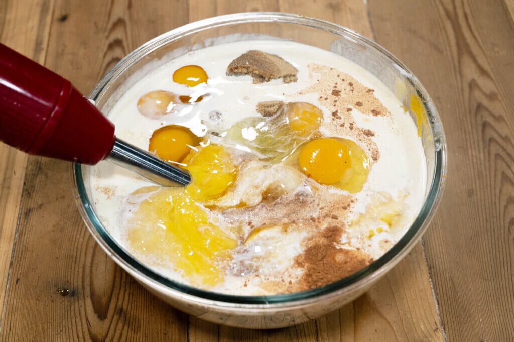 Pumpkin pie filling ingredients in a bowl waiting to be pureed together.