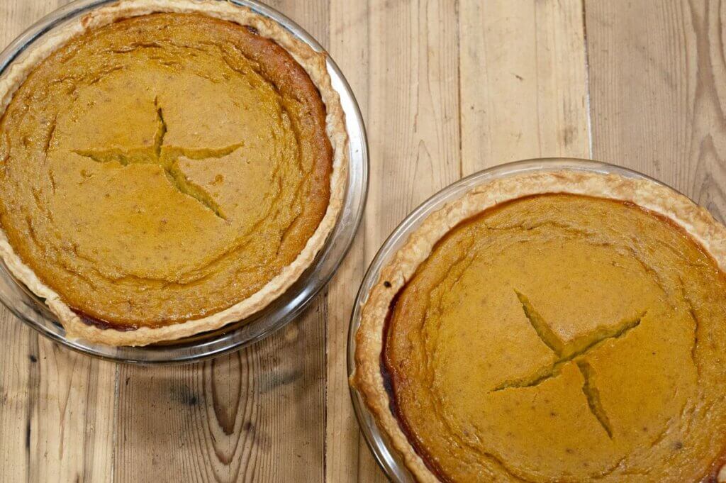 Bird's eye view of two baked pumpkin pies.