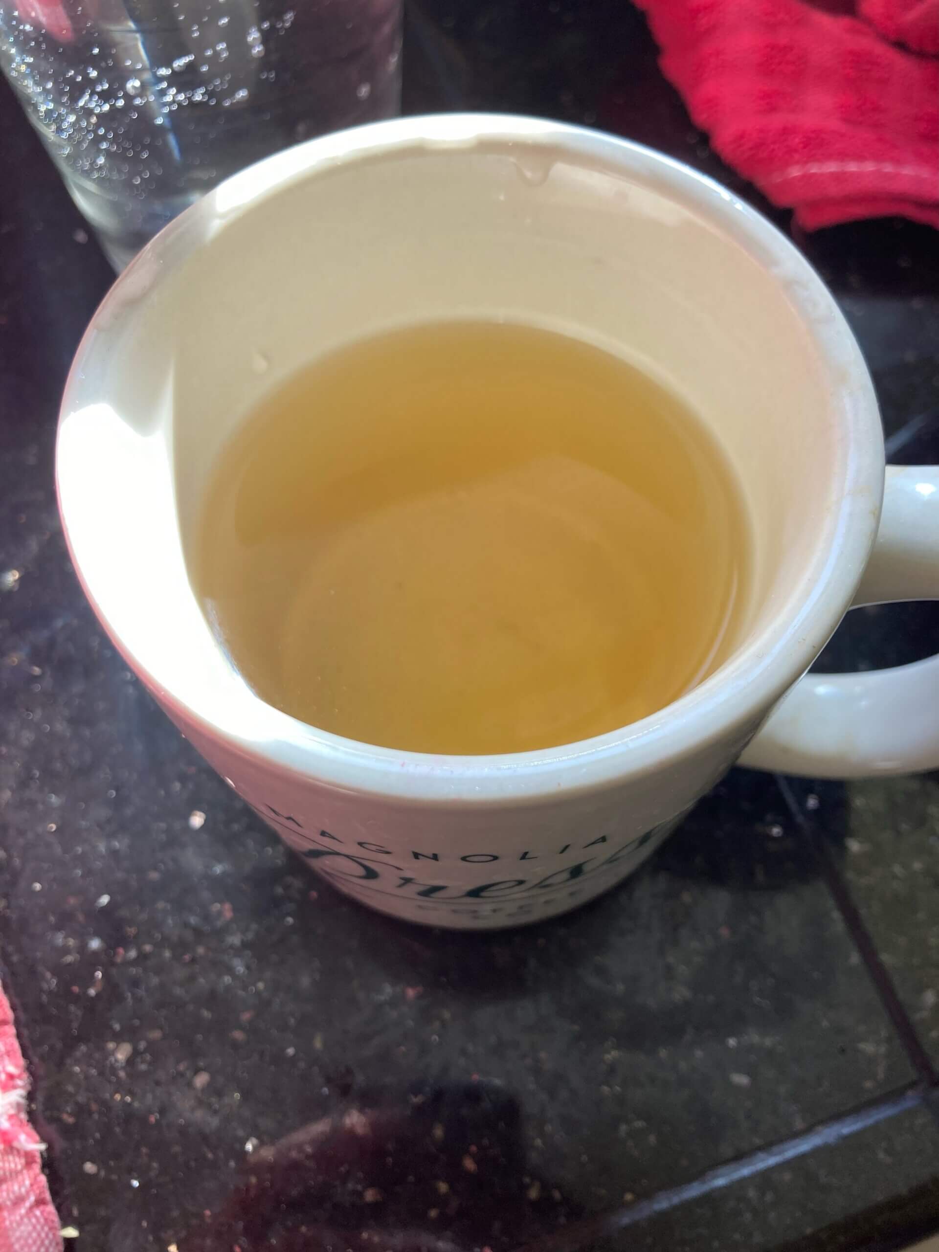 Cup of tea sitting on countertop.