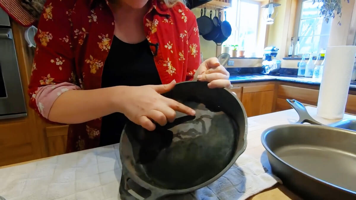 A close up view of a stripped and rinsed cast iron pan ready for seasoning.