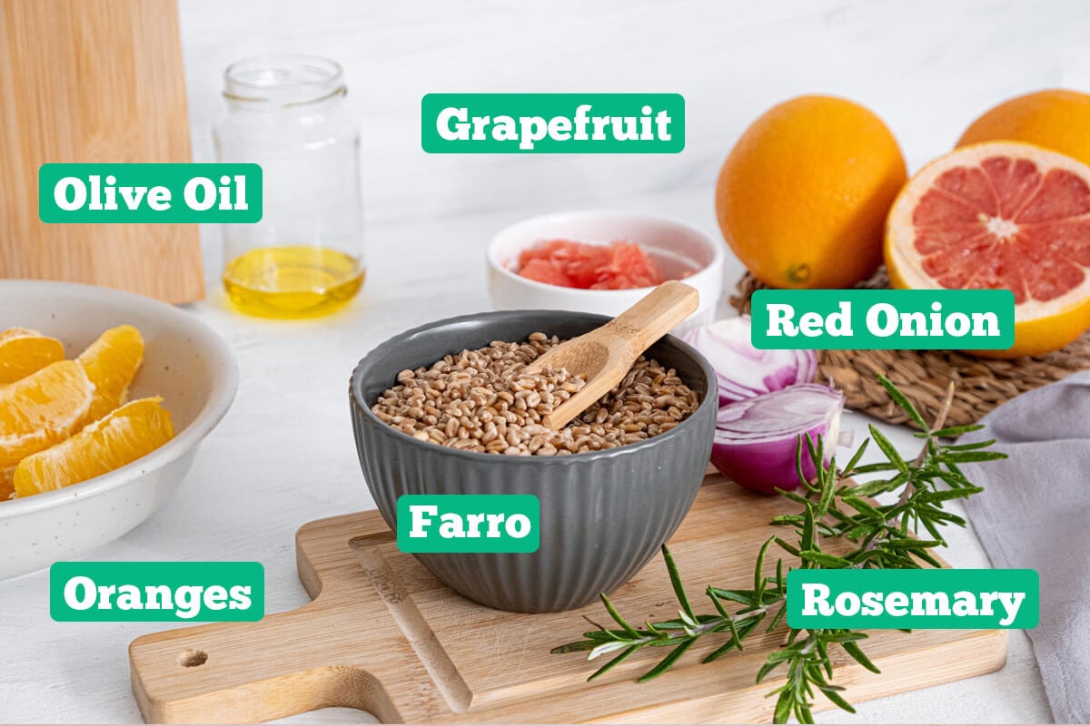 Citrus salad ingredients: grapefruit, oranges, red onion, rosemary, farro, and olive oil.