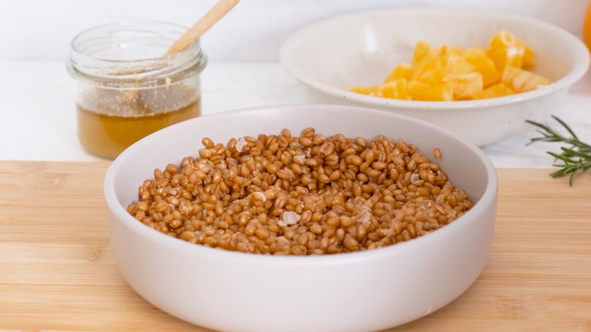 Cooked farro in a white bowl.