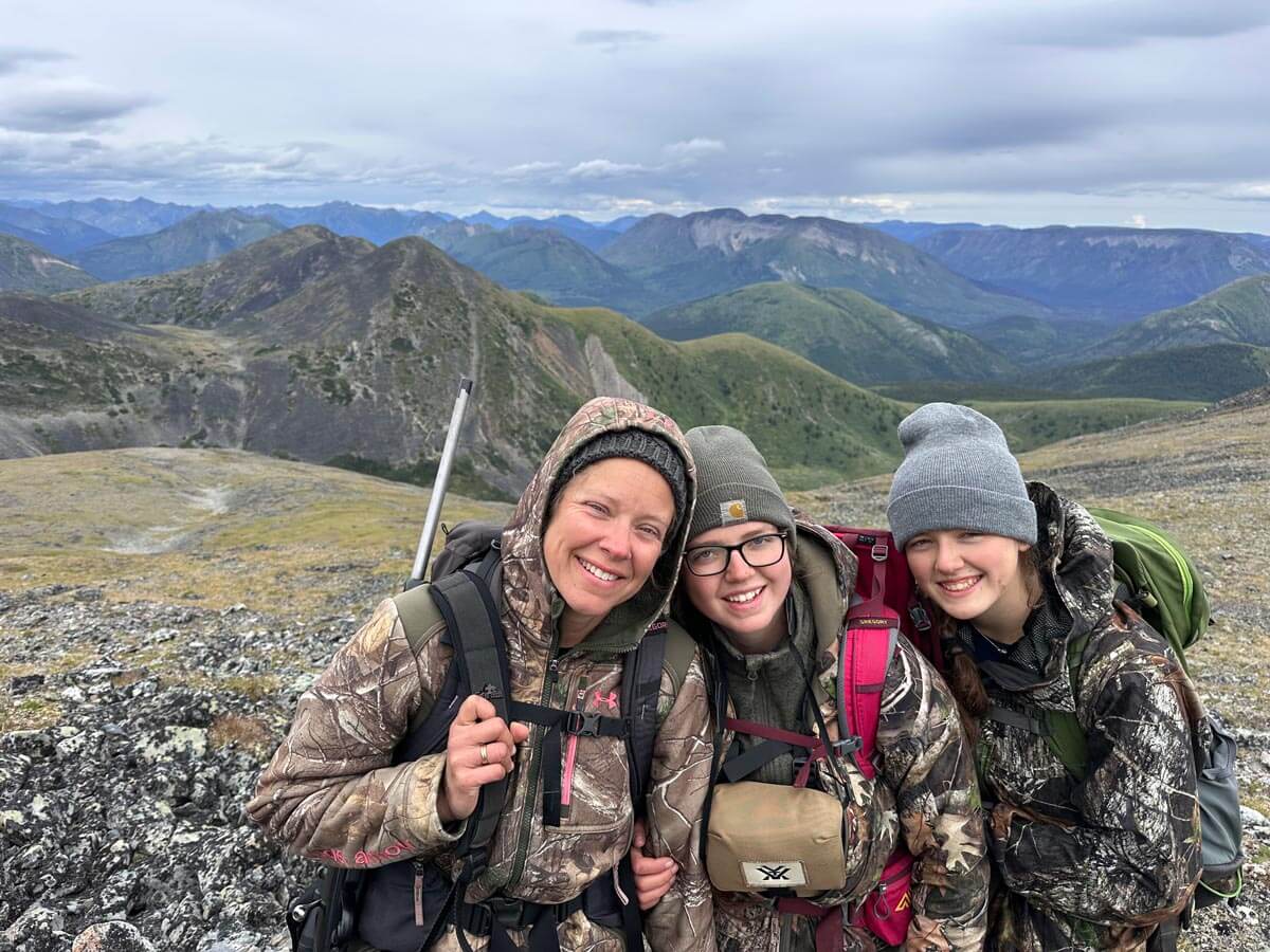 Three girls hunting in the mountains.