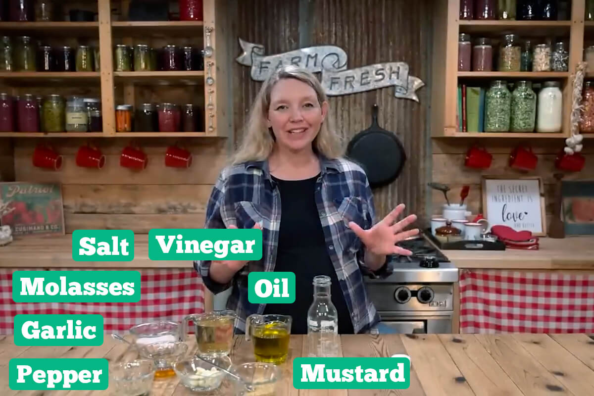 Homemade vinaigrette ingredients: Vinegar, oil, mustard, pepper, garlic, molasses, and salt.