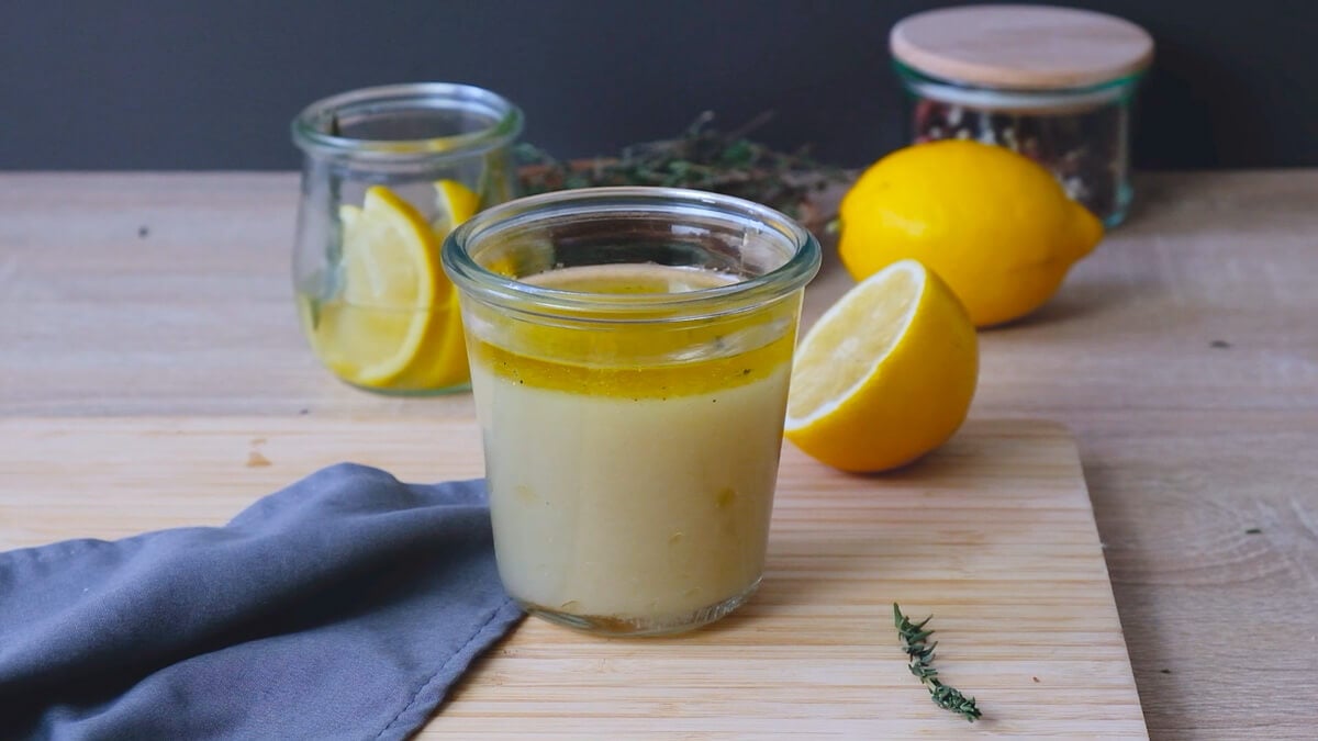 A jar full of lemon sauce for chicken, ready for storage.