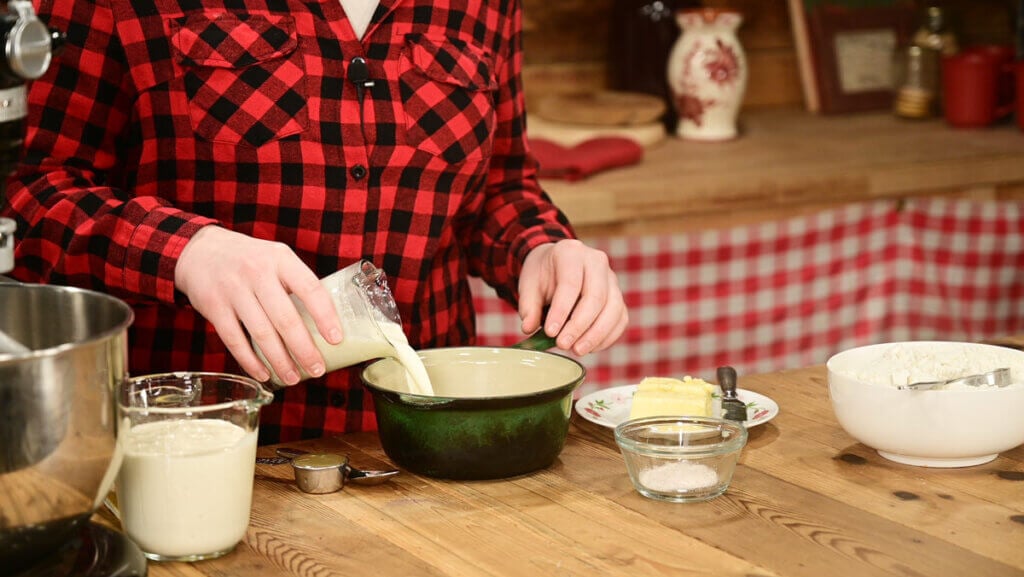 Buttermilk being added to a small pan.
