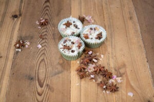 DIY Firestarter arranged with dried star anise, cloves, and flower petals on a wooden countertop.
