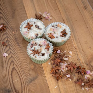 DIY Firestarter arranged with dried star anise, cloves, and flower petals on a wooden countertop.