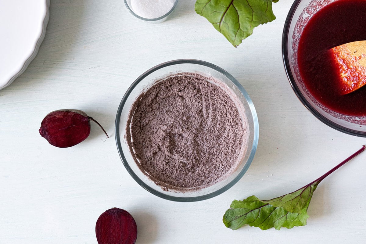 Dry chocolate beet cake ingredients whisked together in a bowl.