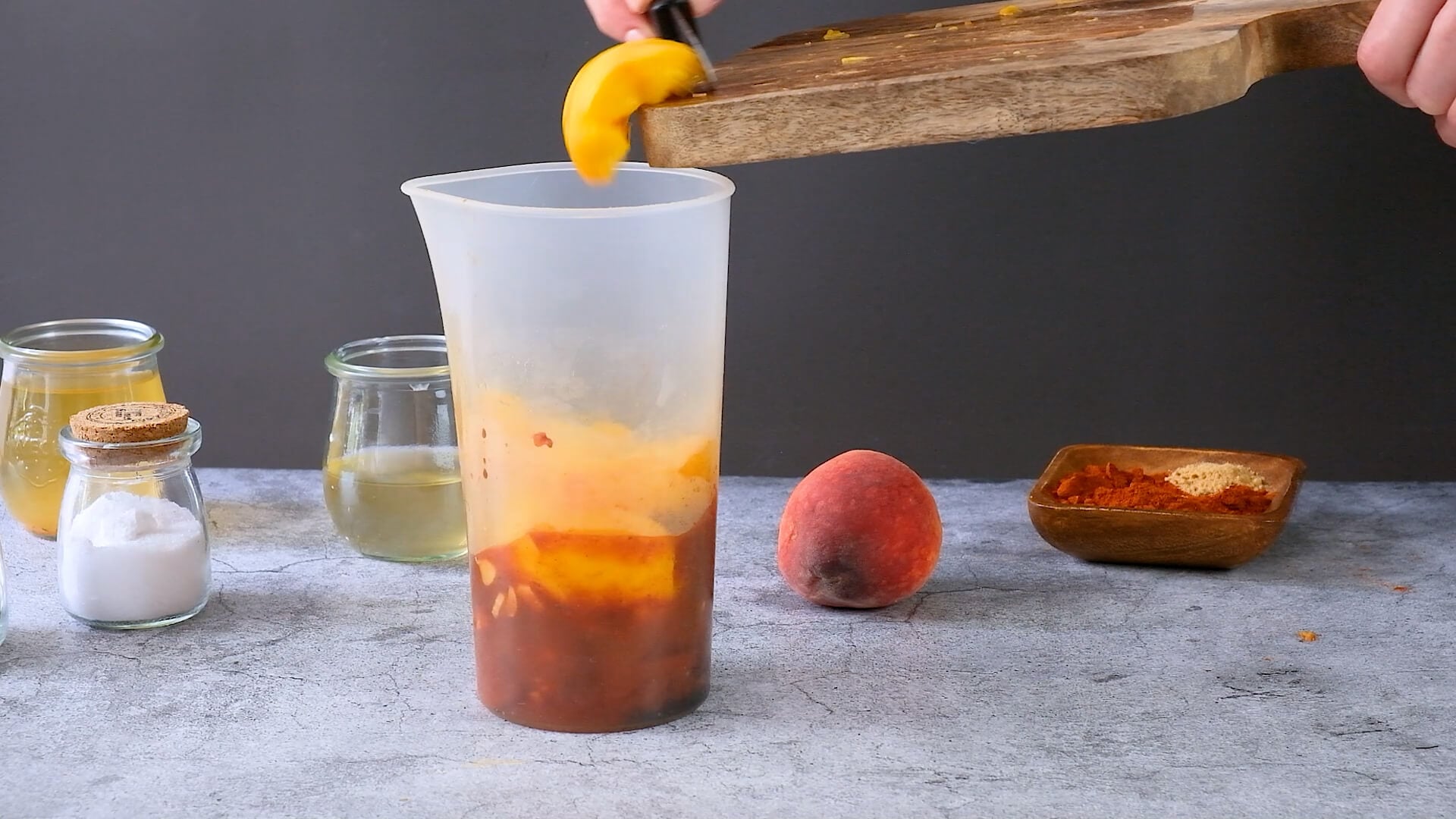 Adding BBQ sauce ingredients to a container before mixing together.