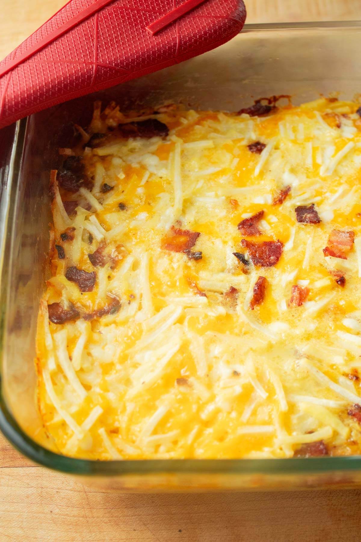 Close up bird's eye view of a baked Amish breakfast casserole in a glass baking dish.