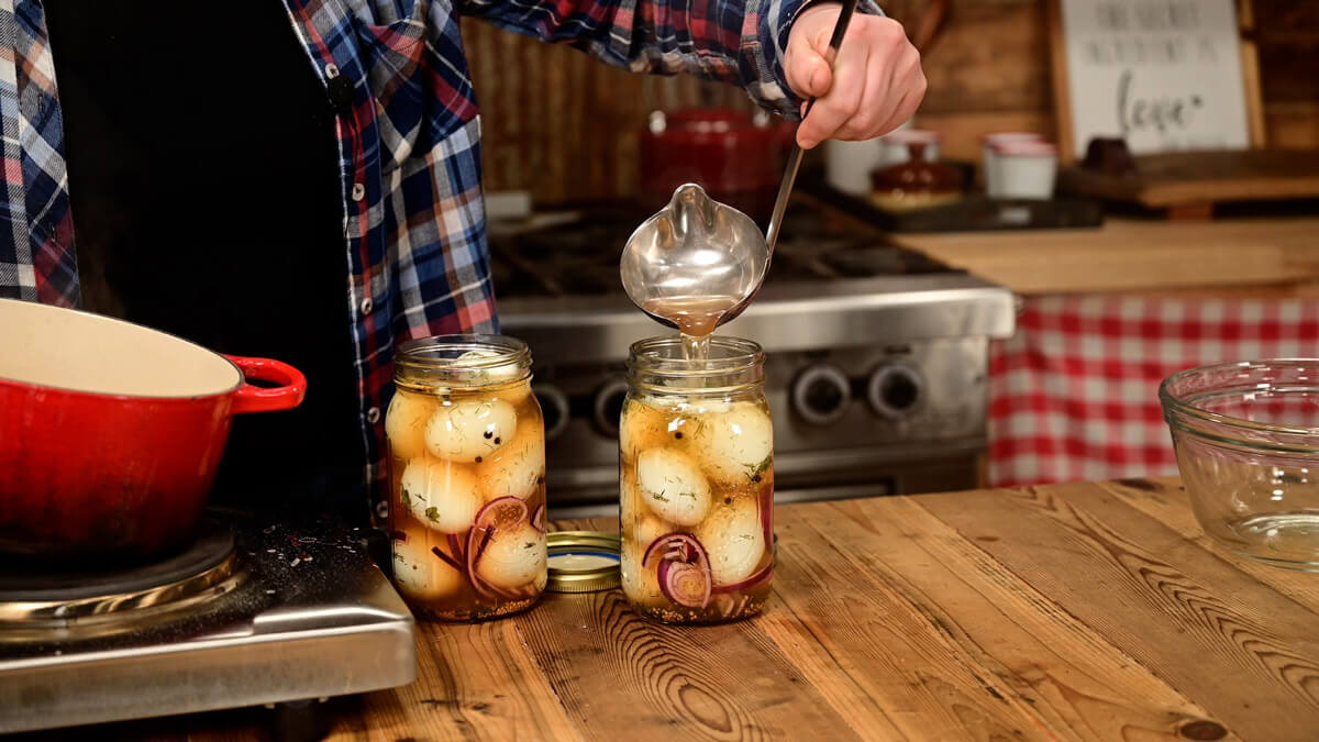Pickled eggs in two Mason jars.