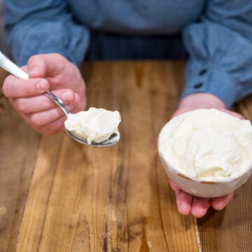 A bowl of ice cream and a scoop on a spoon.