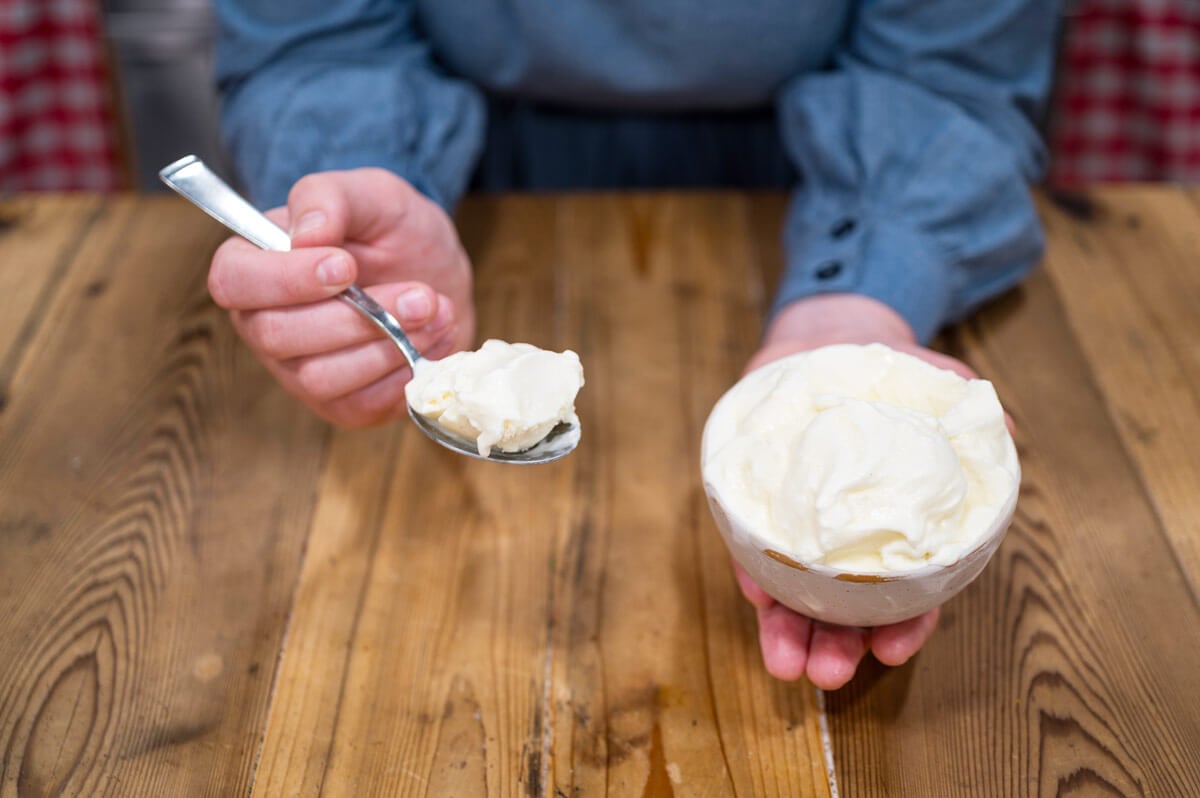 A bowl of ice cream and a scoop on a spoon.