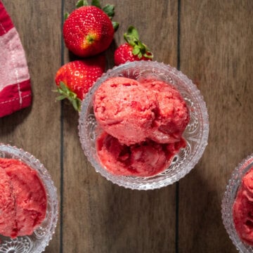 A bird's eye view of three serving dishes filled with strawberry sorbet.