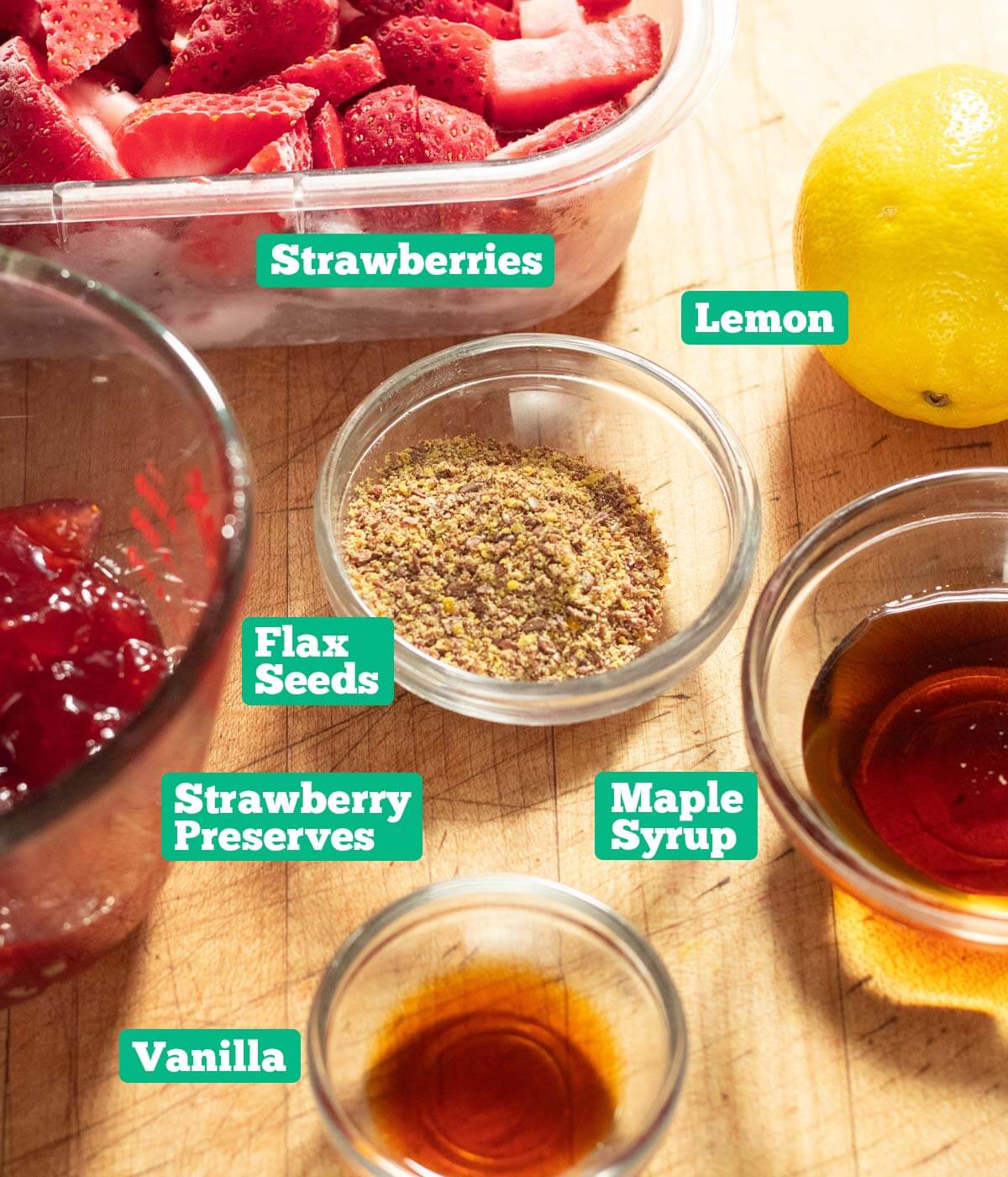 Strawberry sorbet recipe ingredients: strawberries, lemon juice, maple syrup, vanilla, strawberry preserves, and flax seed.