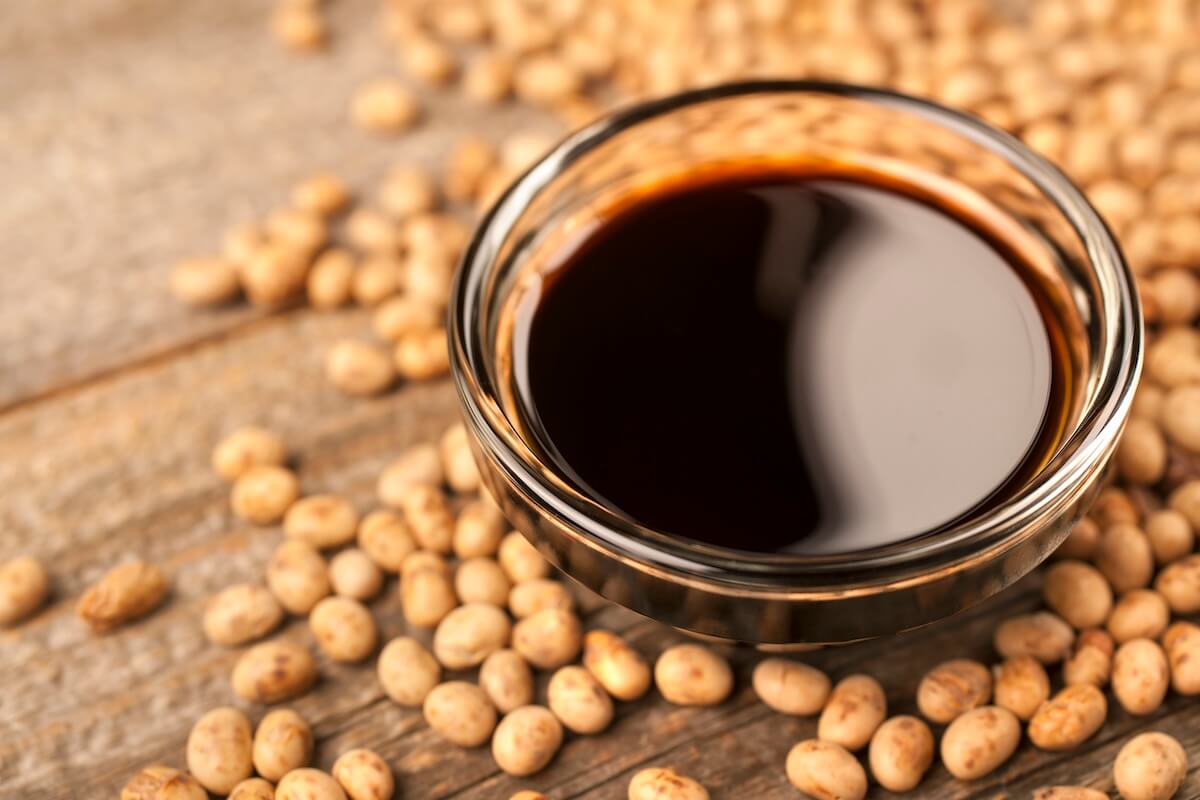 soy sauce with beans spread out on a wooden table