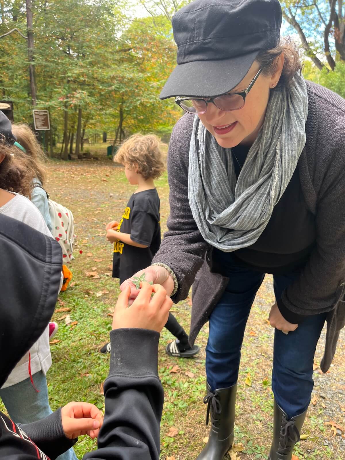 Teacher showing student how to identify a plant.