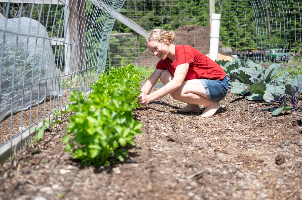A young woman tending to the garden.