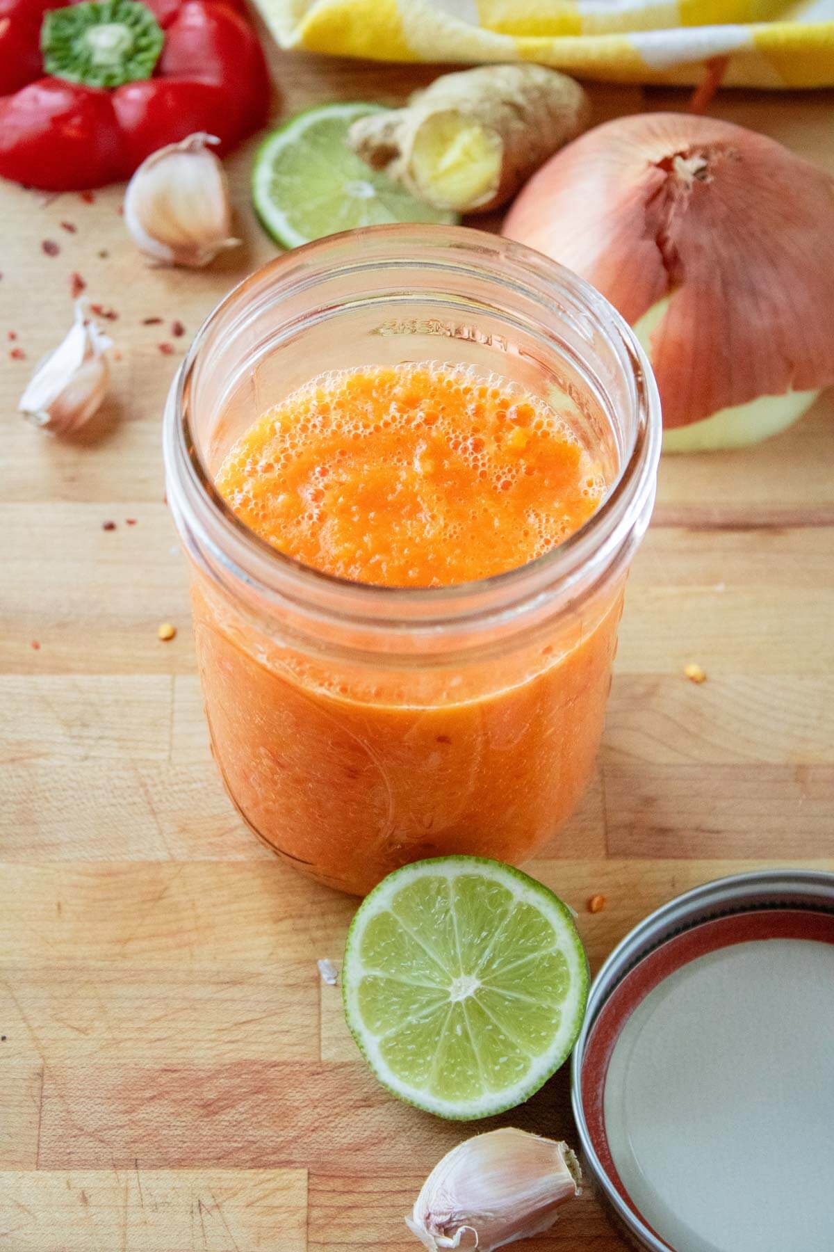 A jar of fermented pepper sauce ready for storage.