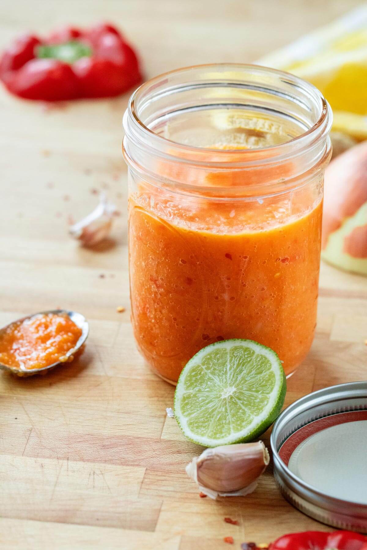 A jar of fermented pepper sauce ready for storage.