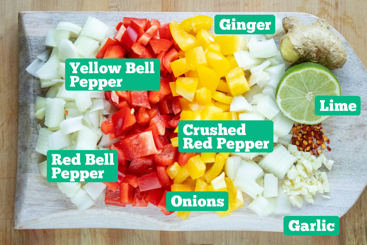 Fermented pepper sauce ingredients: yellow and red bell pepper, onion, ginger, lime, and garlic.