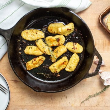 Freshly sauteed gnocchi in a cast iron pan.