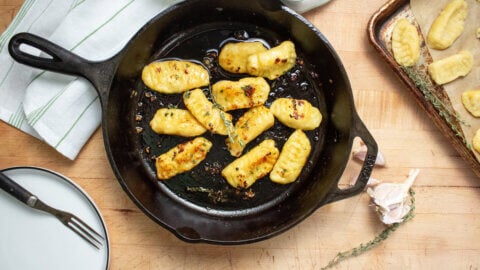 Freshly sauteed gnocchi in a cast iron pan.