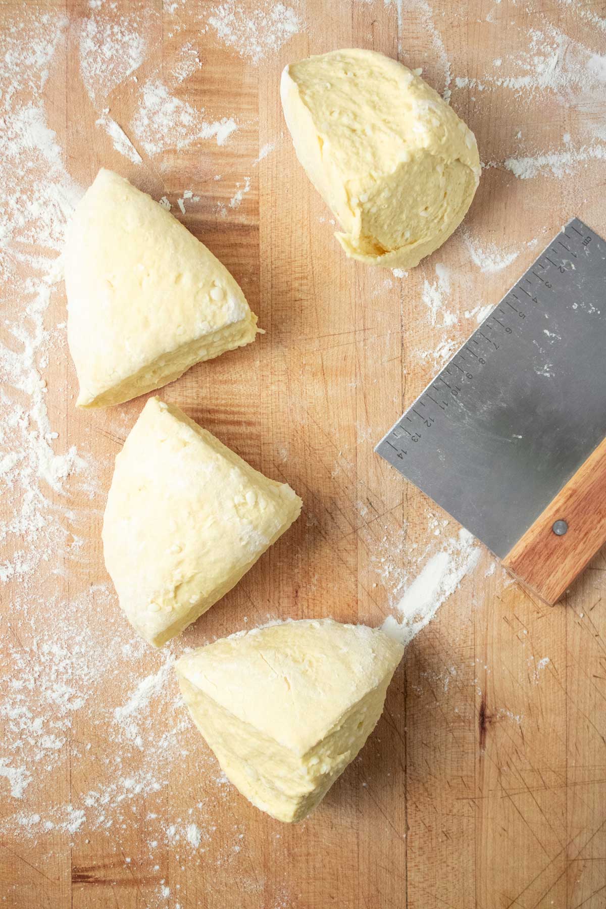 Homemade gnocchi dough divided into four equal pieces.
