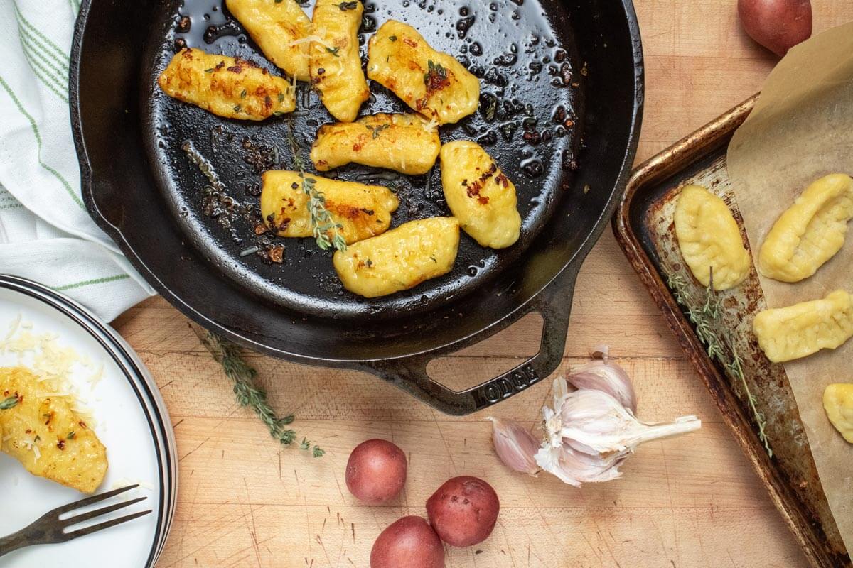 Freshly sauteed gnocchi in a cast iron pan.