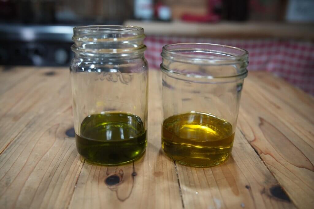Two jars of calendula and comfrey oil side by side.
