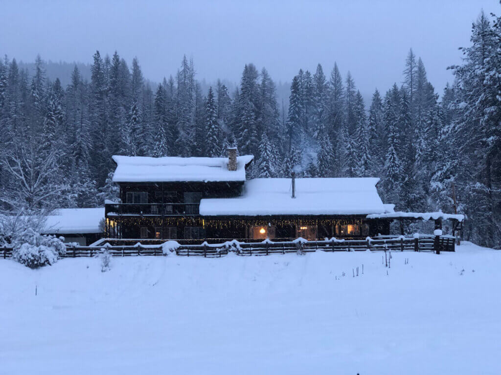 A homestead in the winter with snow.