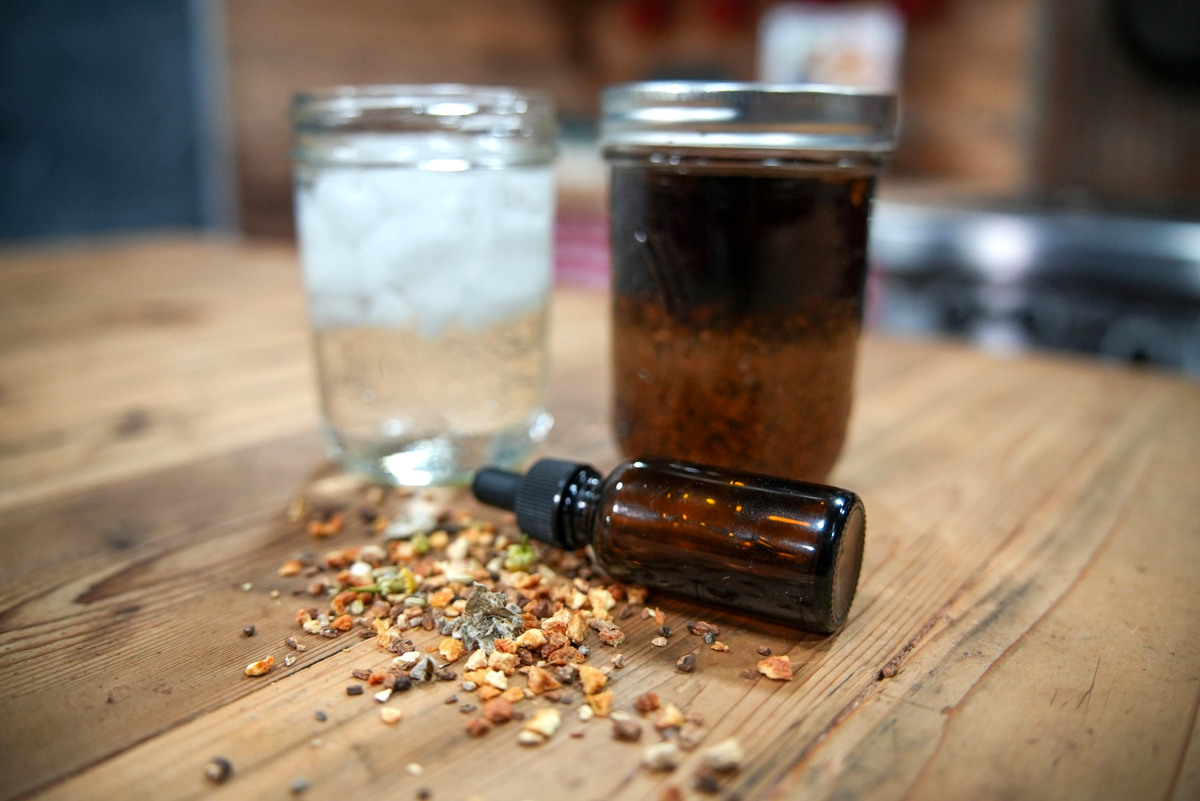 Photo of herbal bitters steeping in a jar.