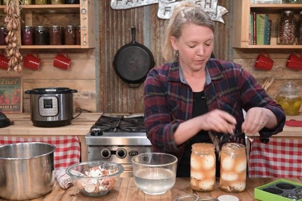 A woman making a funny face after making a mistake in the kitchen.