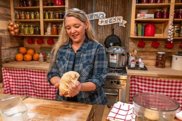 A woman kneading bread dough.