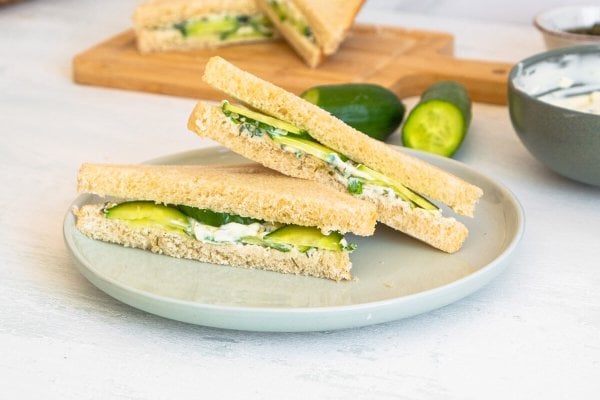 A cucumber sandwich served on a gray plate.