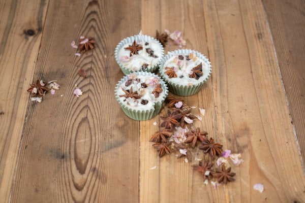 DIY-Firestarter-Feature_HF DIY Firestarter arranged with dried star anise, cloves, and flower petals on a wooden countertop.