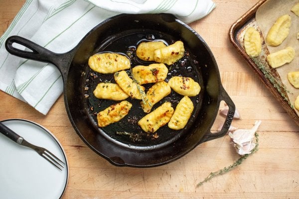 Freshly sauteed gnocchi in a cast iron pan.