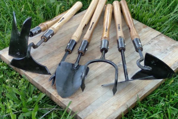 Various steel garden tools with wooden handles.