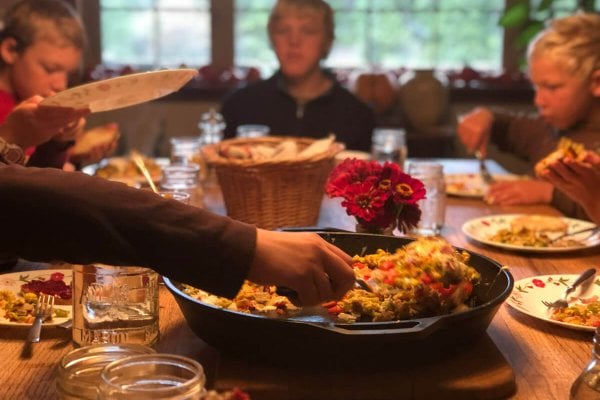 A family sitting down to a meal together.