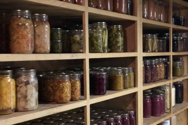 A pantry with shelves lined with home canned food.