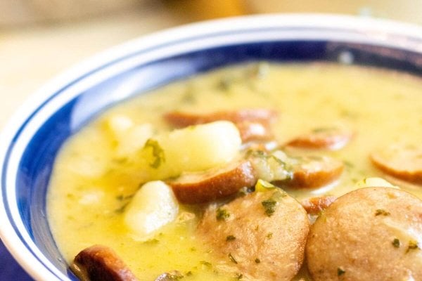 A bowl of sausage and kale soup.