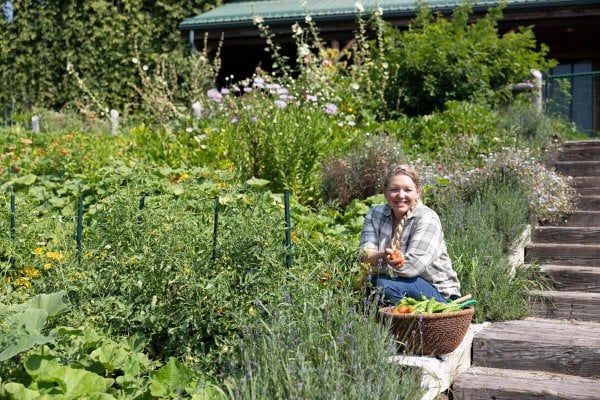 A woman sitting in a terrace garden.